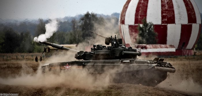 Russian T-90 tank firing in a field