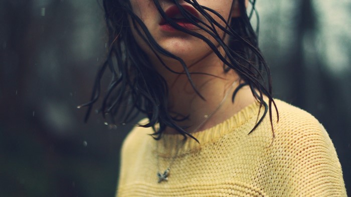 Woman in yellow sweater in the rain