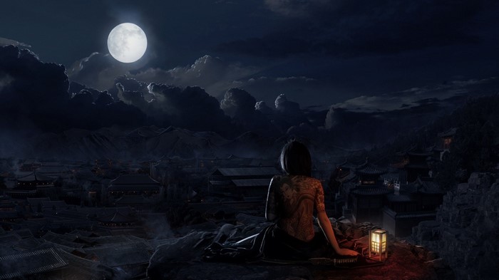 Woman with tattoos at night overlooking oriental city under the moon