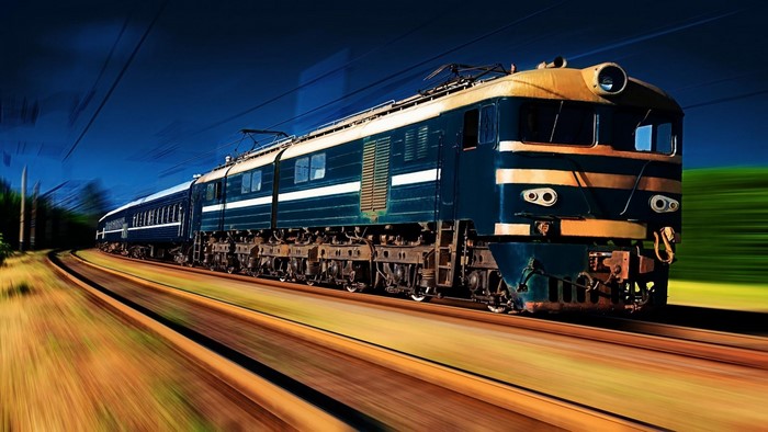 Blue and yellow electric train on tracks