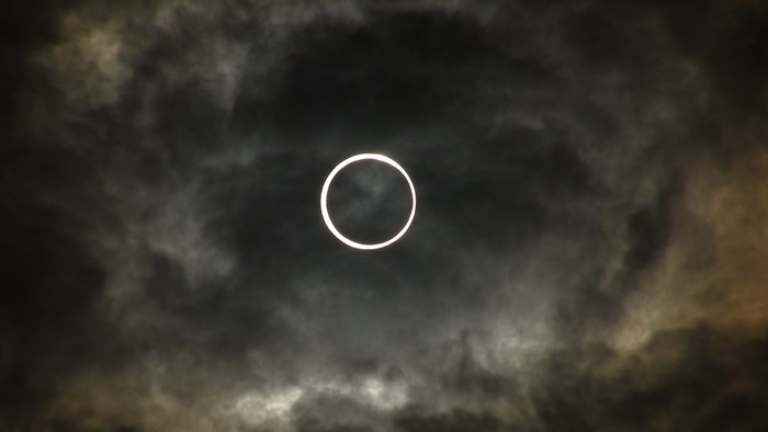 Annular solar eclipse with dark clouds