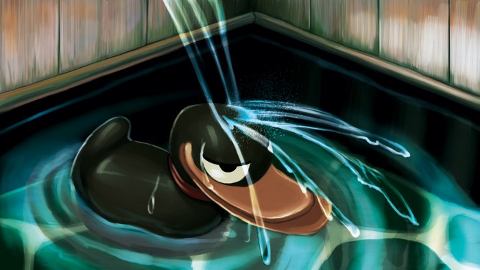 Black rubber duck in water with water pouring on it