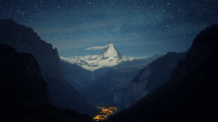 Mountain valley at night with starry sky