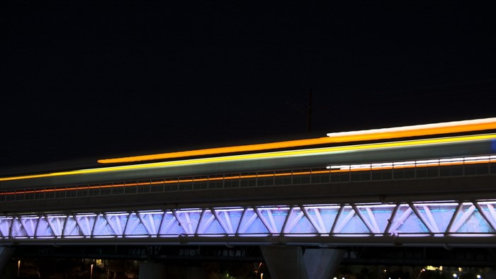 Long exposure of light trails over a bridge at night