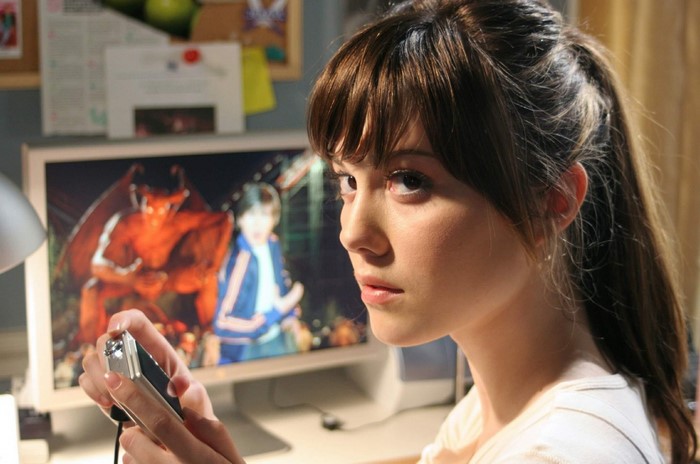 Mary Elizabeth Winstead holding a camera in front of a computer
