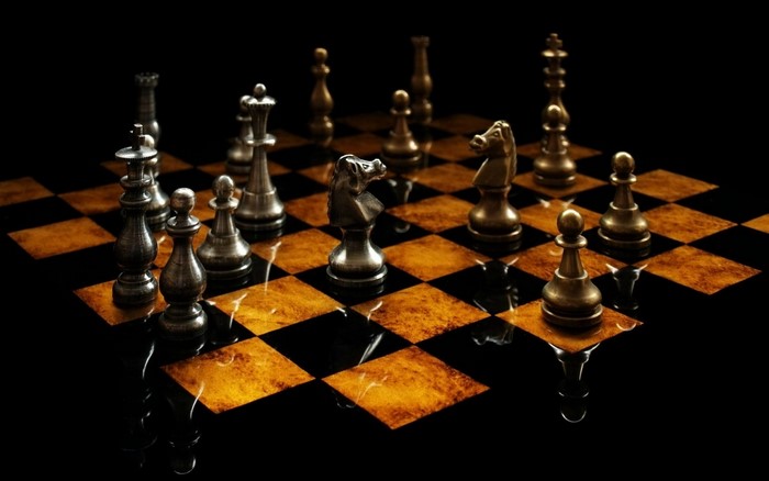 Chessboard with metallic chess pieces