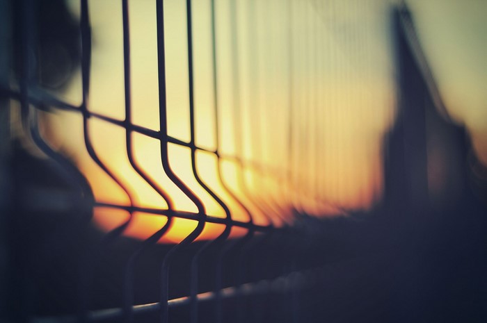 Fence against sunset with silhouette