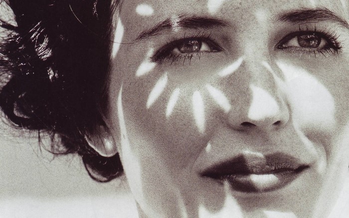 Close-up monochrome portrait of Eva Green with sunlight patterns on her face