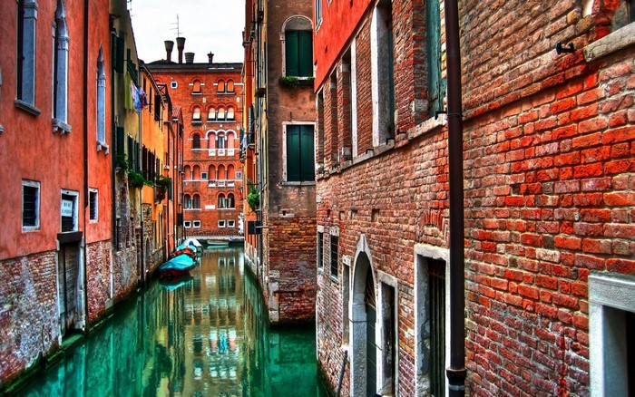 Venice canal with brick buildings and a boat