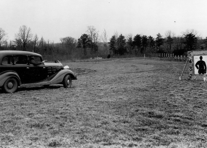 Man in car shooting at targets on a range