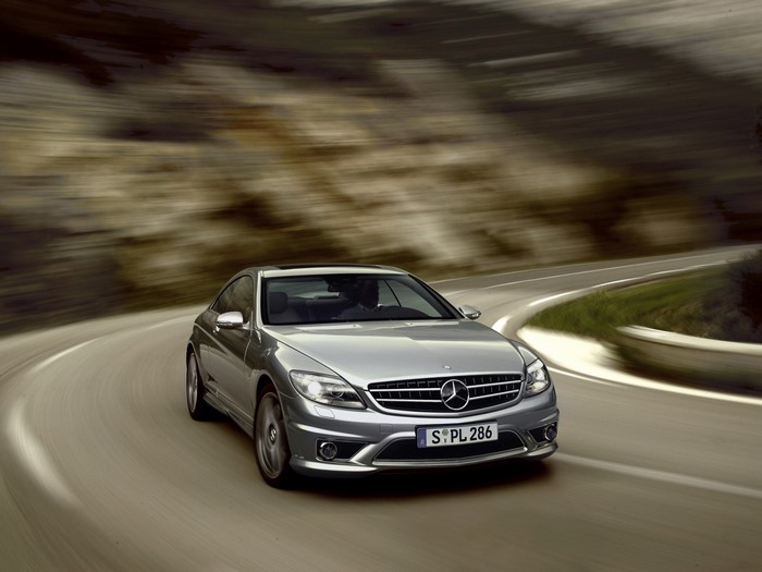 Silver Mercedes-Benz CLS driving on a winding road