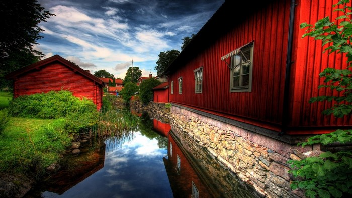 Red wooden houses by a canal in Sweden