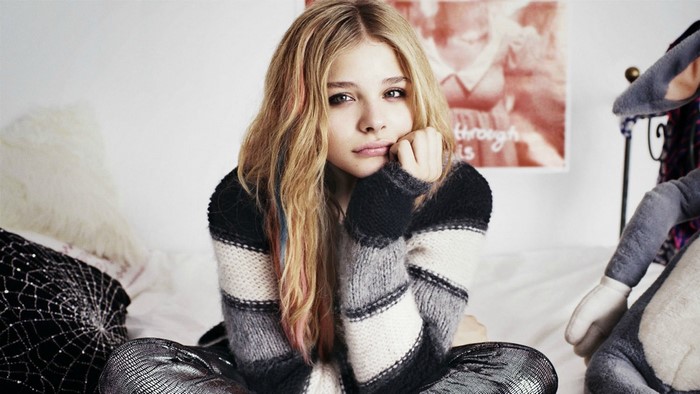 Chloe Grace Moretz in a striped sweater and metallic pants