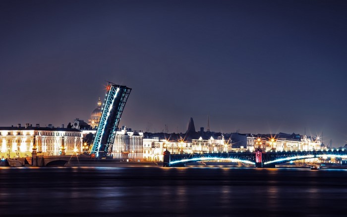 Night view of a drawbridge and city skyline in St. Petersburg