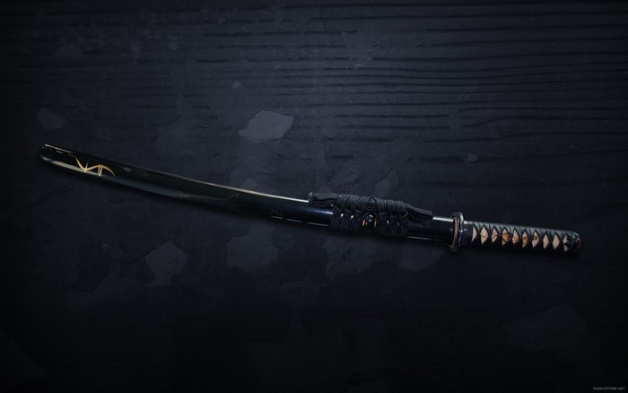 Wakizashi sword on a dark surface