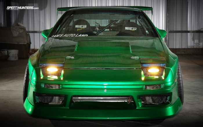 Green Mazda RX-7 with racing seats and custom body kit