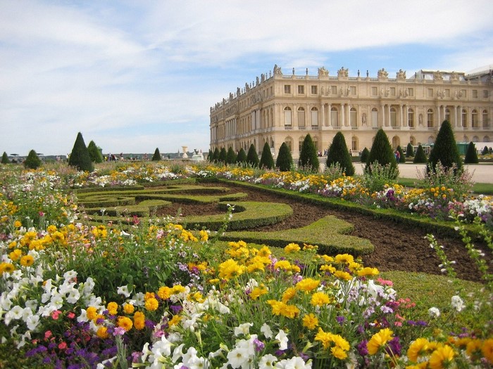 Palace and formal gardens with colorful flowers