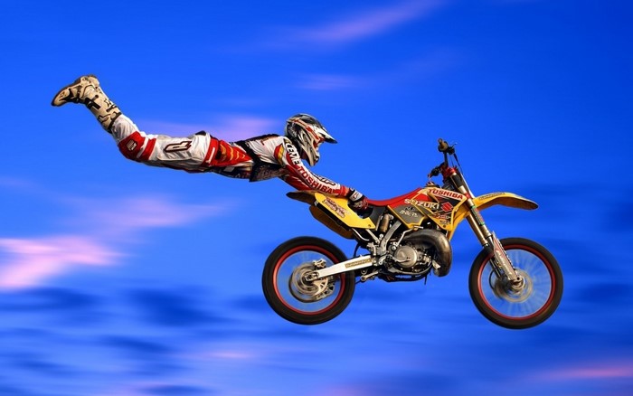 Freestyle Motocross Stunt Over Blue Sky