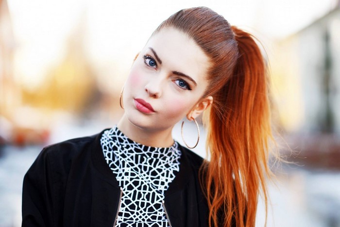 Redhead woman with blue eyes in a ponytail