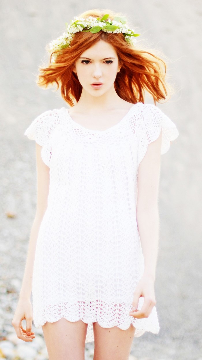 Redhead woman with flower crown in white dress