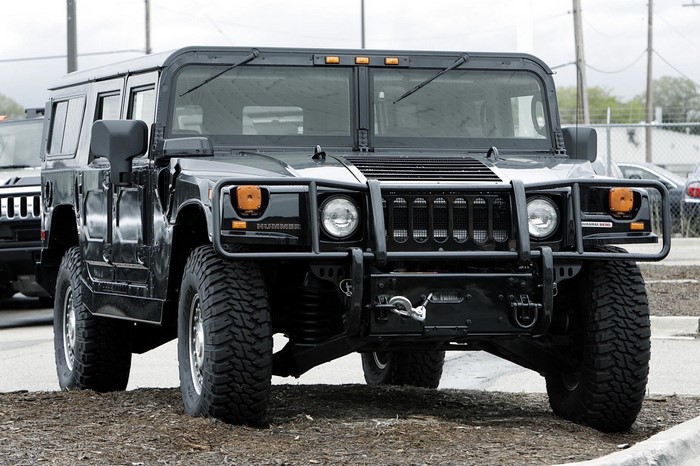 Black Hummer H1 parked on dirt