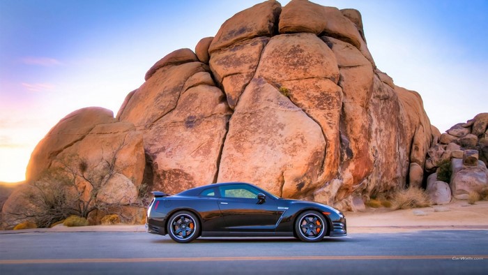 Black Nissan GT-R parked near rock formations