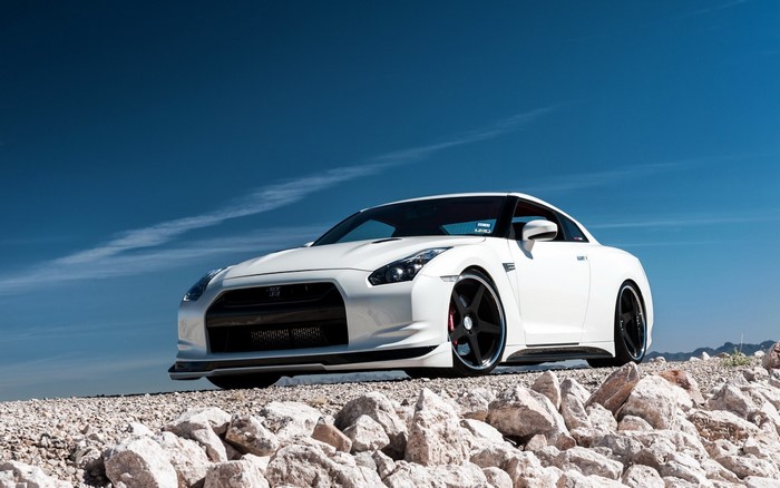 White Nissan GT-R parked on rocky terrain