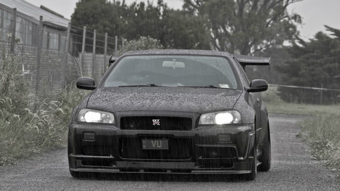 Black Nissan Skyline GT-R R34 in the rain