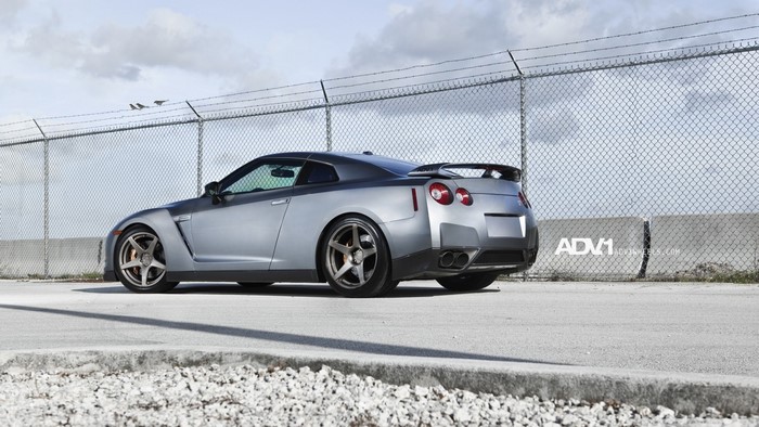 Nissan GT-R R35 sports car parked near a fence