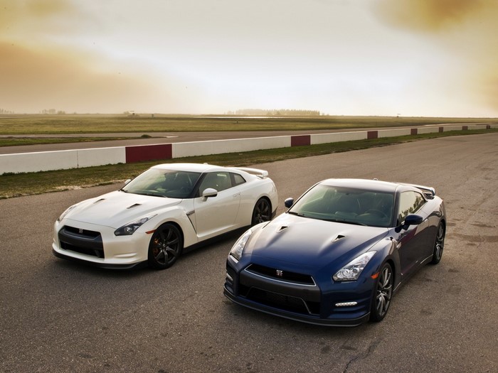 Two Nissan GT-R sports cars on a racetrack