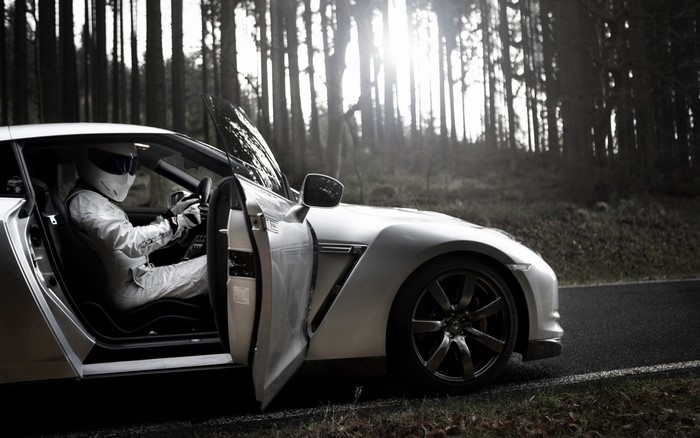 The Stig in a Nissan GT-R in a forest