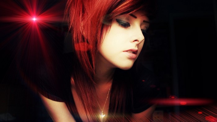 Woman with red hair and dramatic lighting