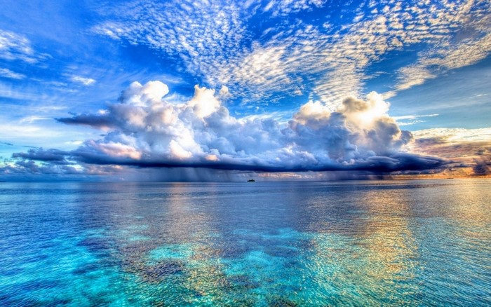 Ocean with dramatic clouds and sunlight