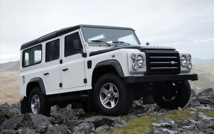 White Land Rover Defender on rocky terrain
