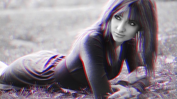 Woman with blue and red anaglyph effect lying on grass