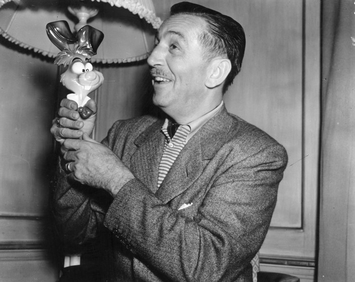 Walt Disney holding a rabbit toy