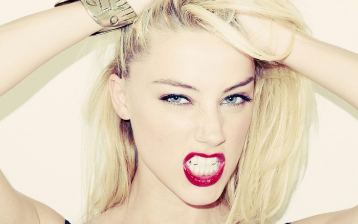 Amber Heard with blonde hair and red lipstick
