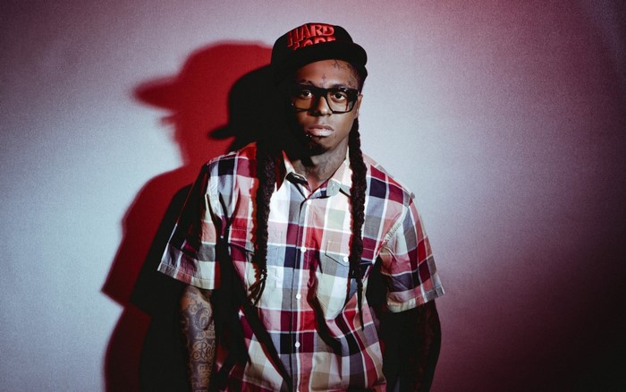 Lil Wayne wearing glasses and a plaid shirt