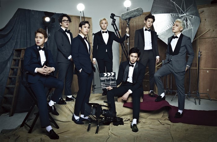 Block B members in formal wear with film equipment