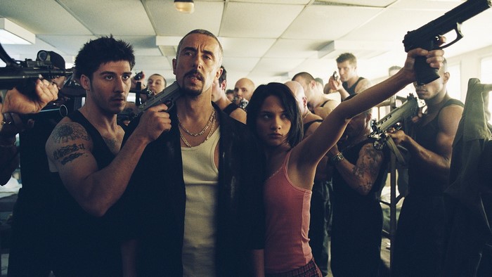 Group of men and a woman holding guns
