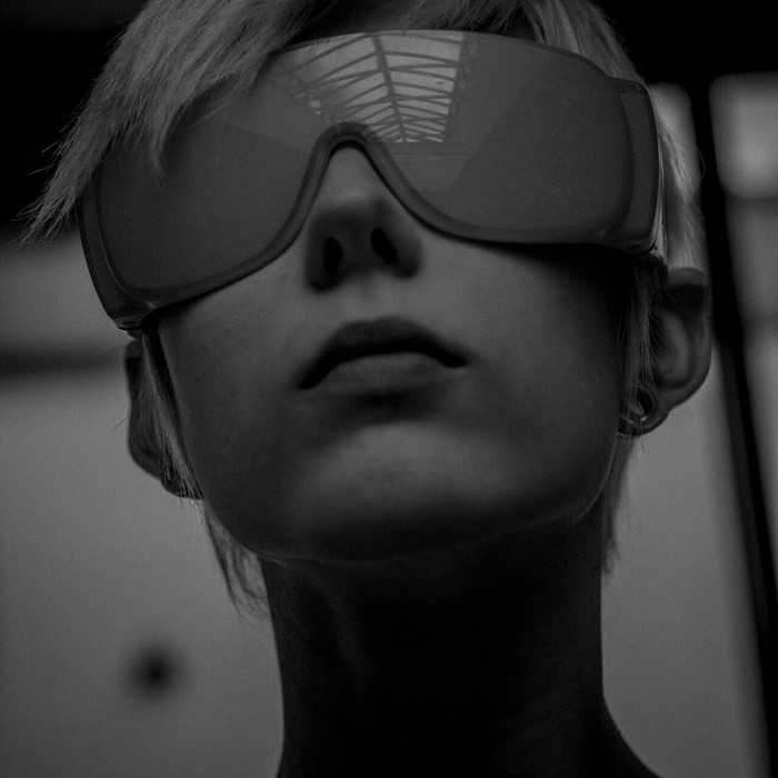 Woman wearing large sunglasses, close-up monochrome portrait