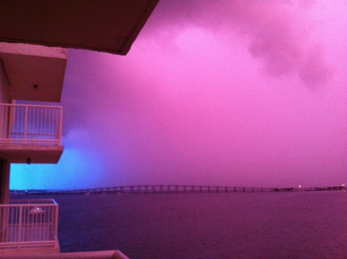 Balcony overlooking a bridge at sunset with pink and blue light