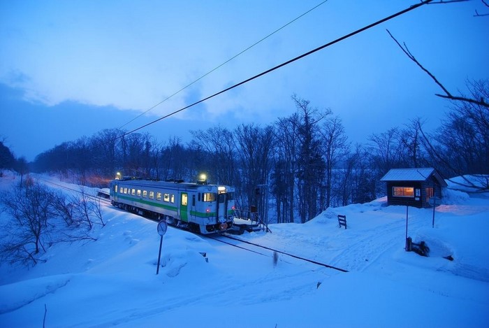 Train in a snowy landscape at dusk