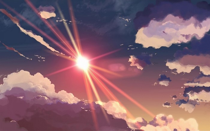 Sun rays shining through clouds at sunset