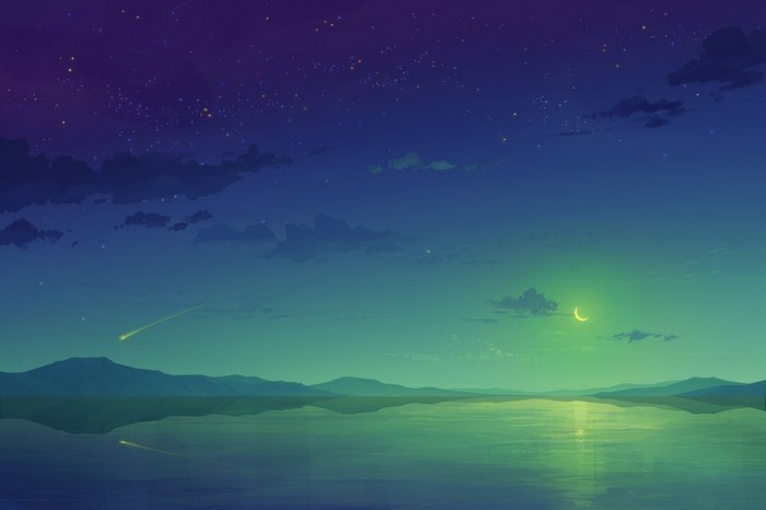 Night sky over a calm body of water with mountains
