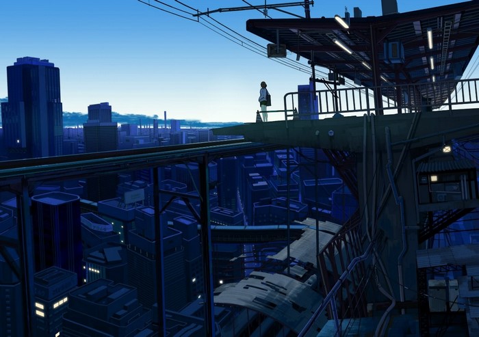 Girl on a train station platform overlooking a cityscape