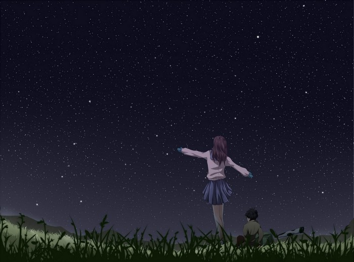 Two people stargazing at night