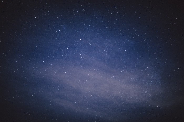 Starry night sky with a faint nebula