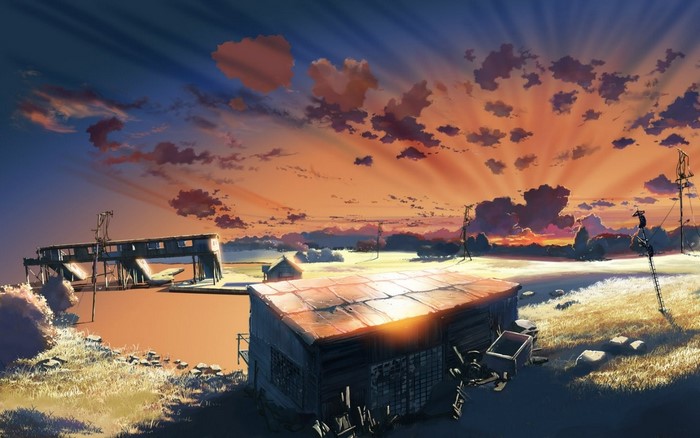 Sunset over abandoned structures and fields