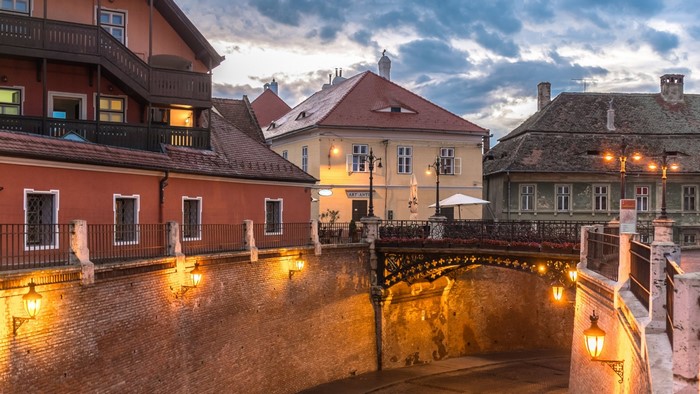 Old European town with canal and bridge at dusk